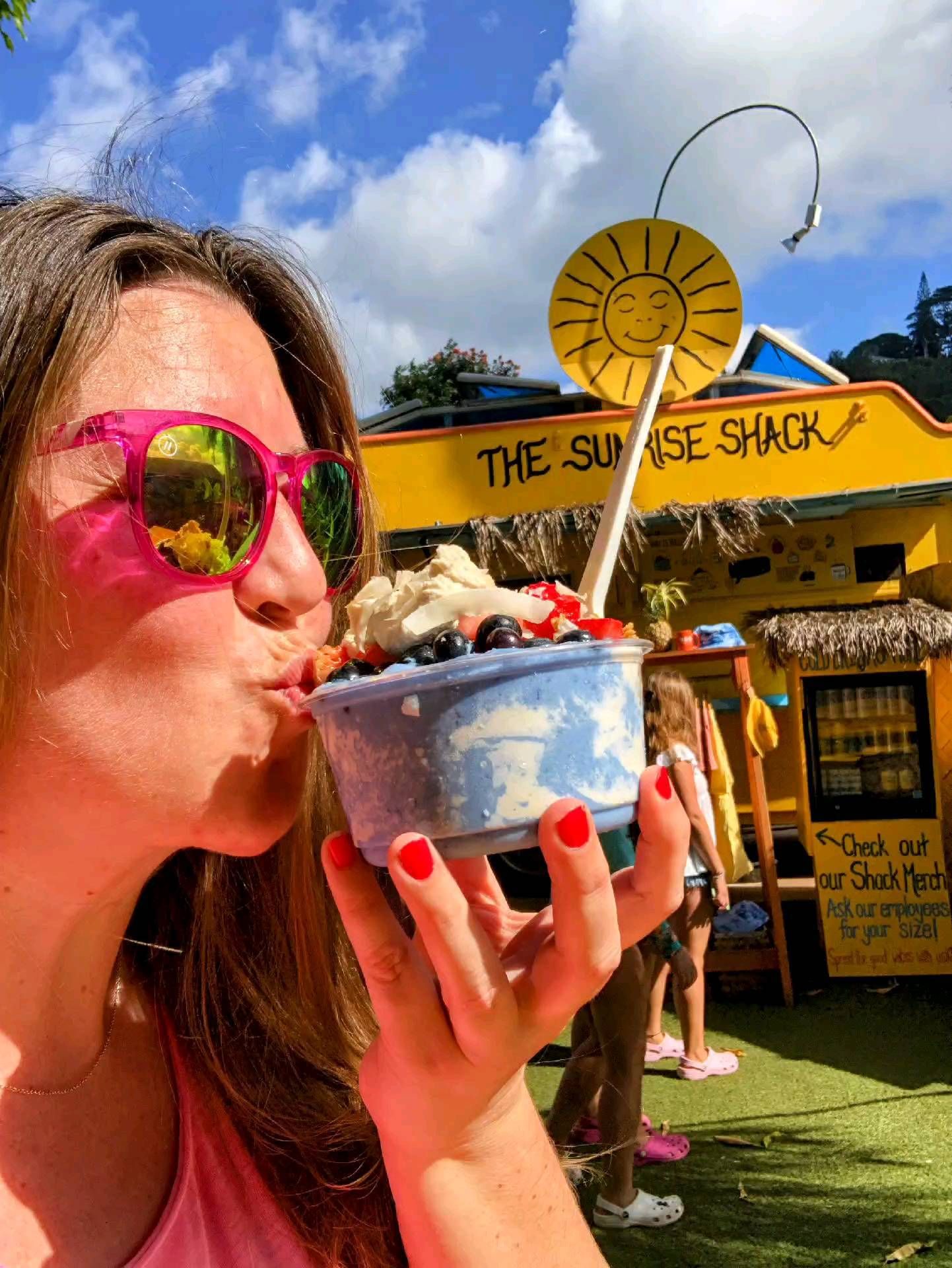 Laura planting a kiss on a giant bowl of dessert